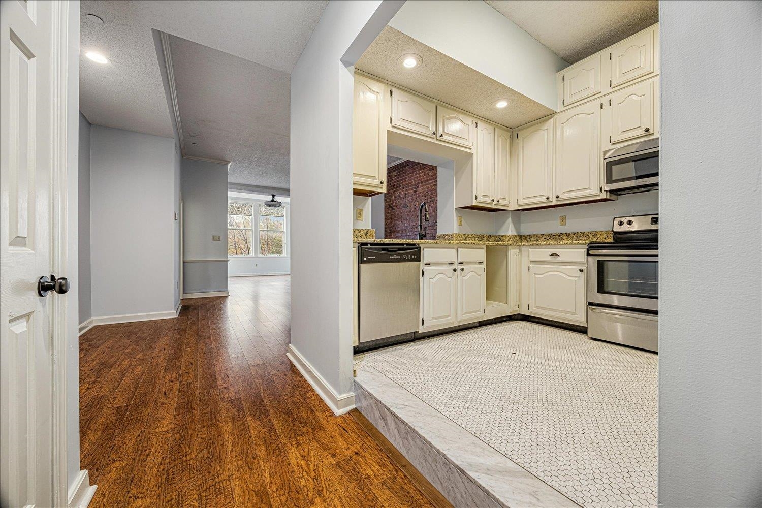 10 North Main Street, Unit 301 Memphis, TN 38103 - Photo 24 of 31 a kitchen with stainless steel appliances a stove top oven a sink and a refrigerator