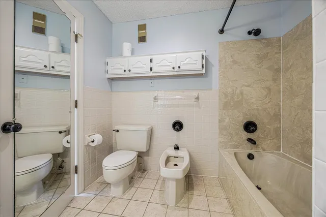 a bathroom with a toilet sink and shower