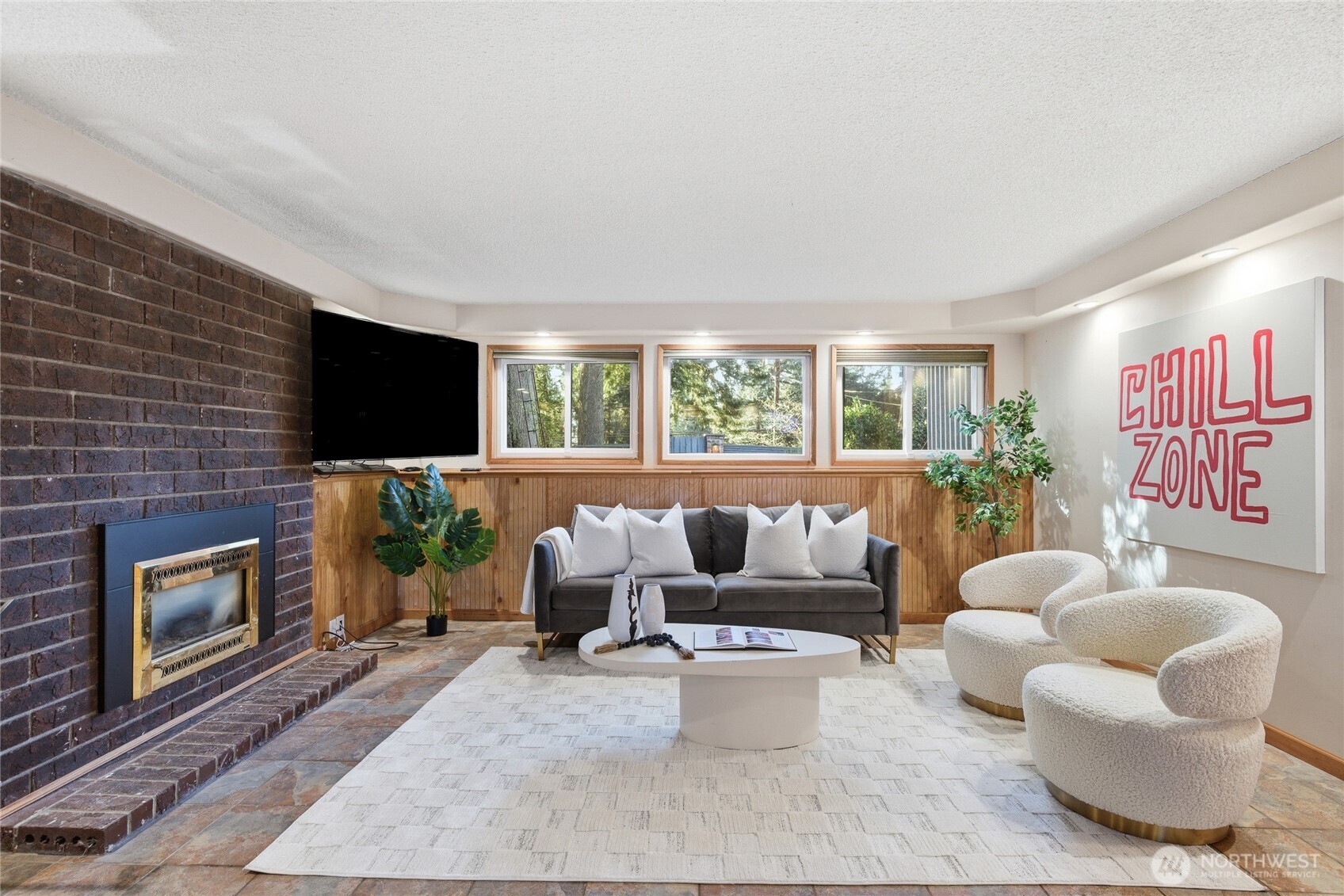 13011 Seattle Hill Road Snohomish, WA 98296 - Photo 21 of 40 a living room with furniture a flat screen tv and a fireplace