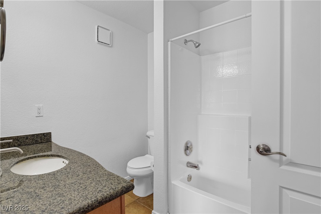 9325 West Desert Inn Road, Unit 177 Las Vegas, NV 89117 - Photo 12 of 13 Full bath featuring vanity, shower / bath combination, and tile patterned floors