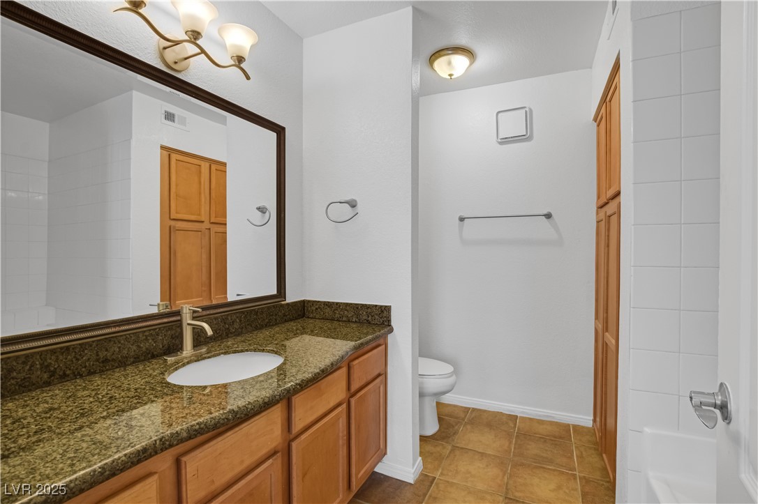 9325 West Desert Inn Road, Unit 177 Las Vegas, NV 89117 - Photo 9 of 13 Bathroom featuring vanity, tile patterned floors, and tub / shower combination