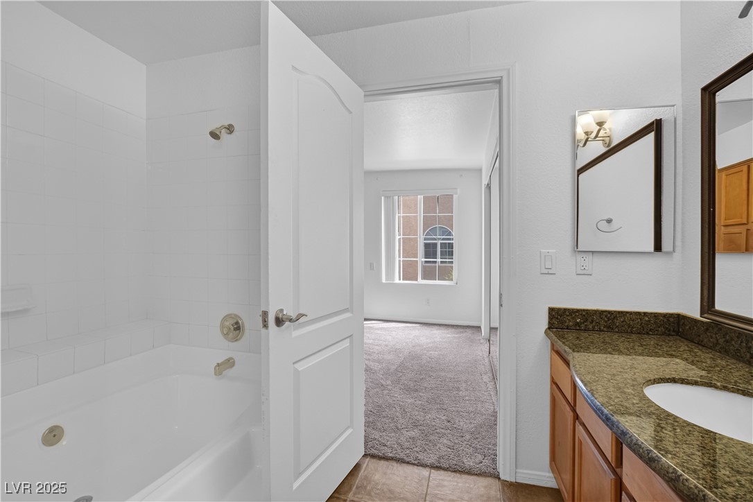 9325 West Desert Inn Road, Unit 177 Las Vegas, NV 89117 - Photo 10 of 13 Full bath featuring vanity, washtub / shower combination, and tile patterned floors