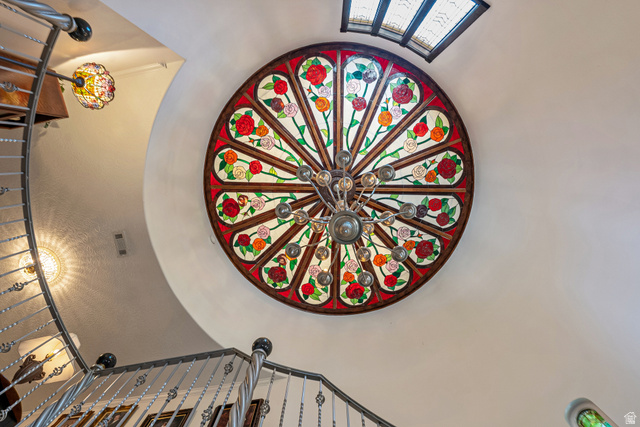 4093 North Imperial Way Provo, UT 84604 - Photo 9 of 96 Circular stained glass ceiling fixture with a central chandelier, showcasing floral motifs