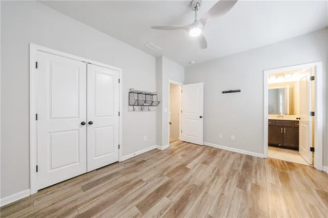 wooden floor in an empty room with a bathroom