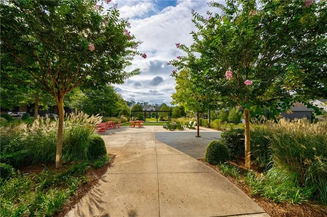 a view of a patio with table and chairs and potted plants
