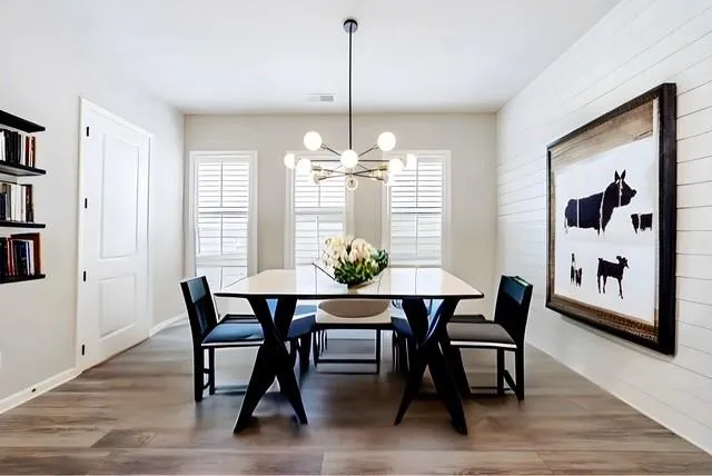 a dining room with furniture a rug and a chandelier