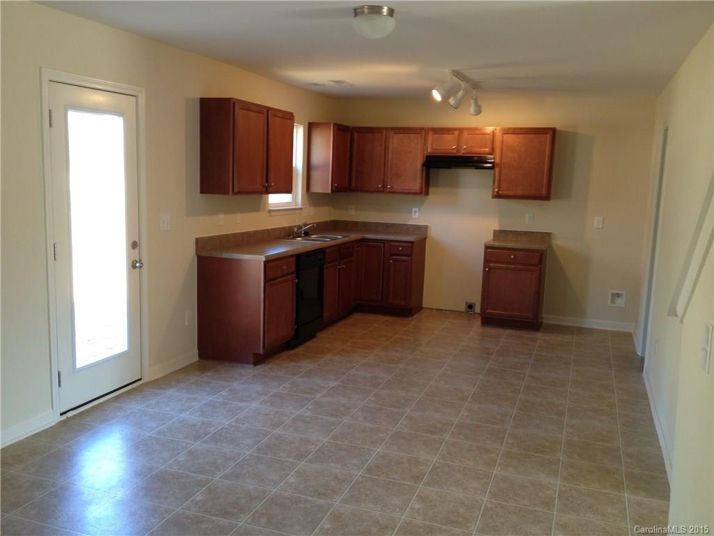 2062 Gunnars Ridge Road, Unit 32 Lancaster, SC 29720 - Photo 4 of 20 a kitchen with stainless steel appliances granite countertop wooden cabinets a stove top oven a sink and dishwasher