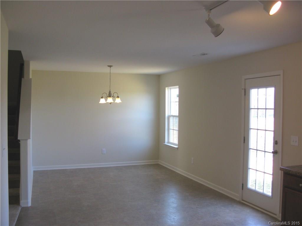 2062 Gunnars Ridge Road, Unit 32 Lancaster, SC 29720 - Photo 9 of 20 an empty room with windows and chandelier fan