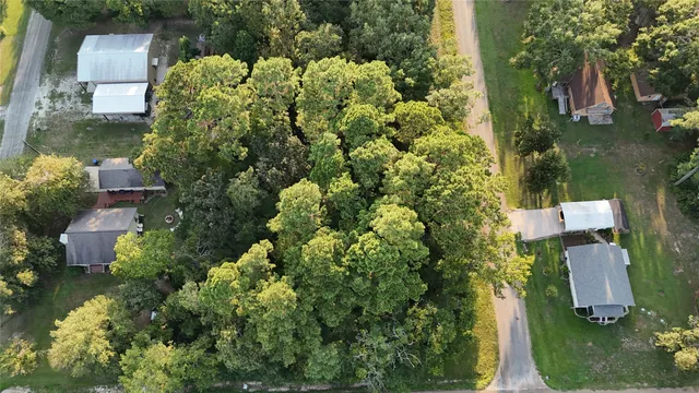 an aerial view of a house with a yard and garden