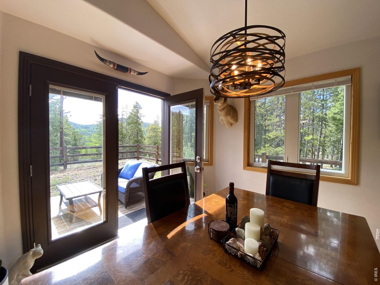 28 Valley View Lane Evergreen, CO 80439 - Photo 13 of 37 a living room with furniture and floor to ceiling windows