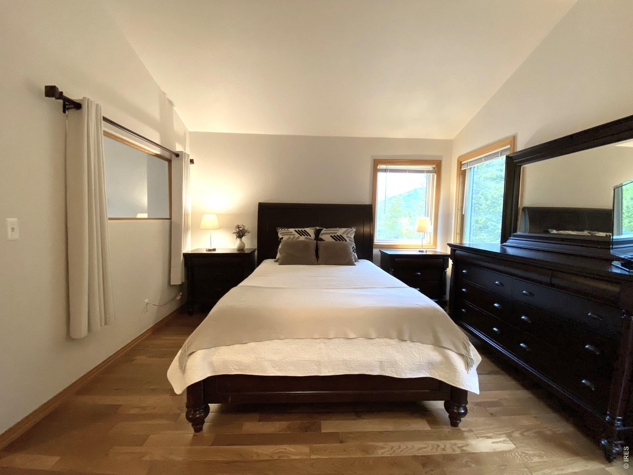 28 Valley View Lane Evergreen, CO 80439 - Photo 14 of 37 a bedroom with a bed and a flat screen tv