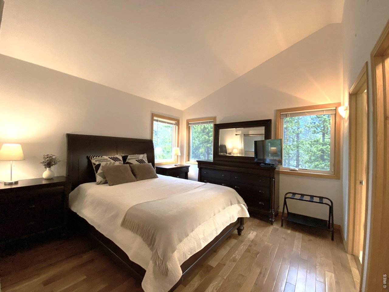 28 Valley View Lane Evergreen, CO 80439 - Photo 15 of 37 a bedroom with a bed and a tv on table