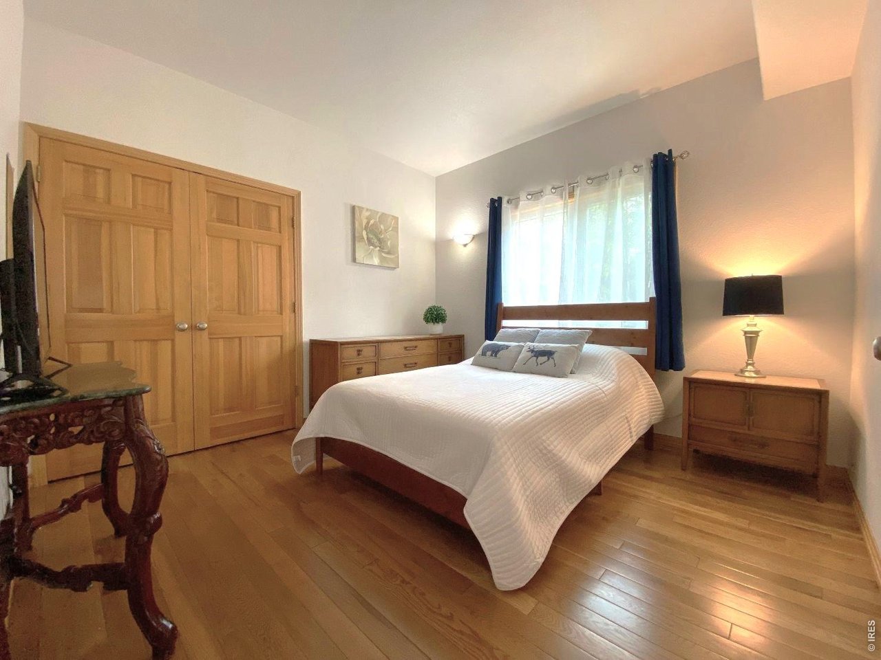 28 Valley View Lane Evergreen, CO 80439 - Photo 16 of 37 a bedroom with a bed and a flat tv screen on dresser