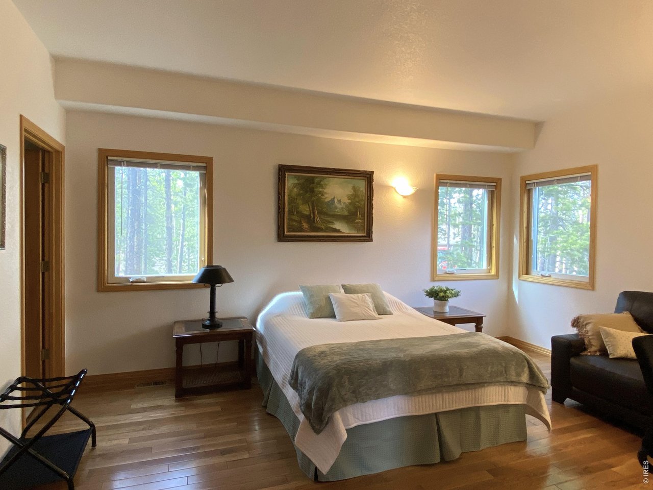 28 Valley View Lane Evergreen, CO 80439 - Photo 17 of 37 a bedroom with a bed and wooden floor