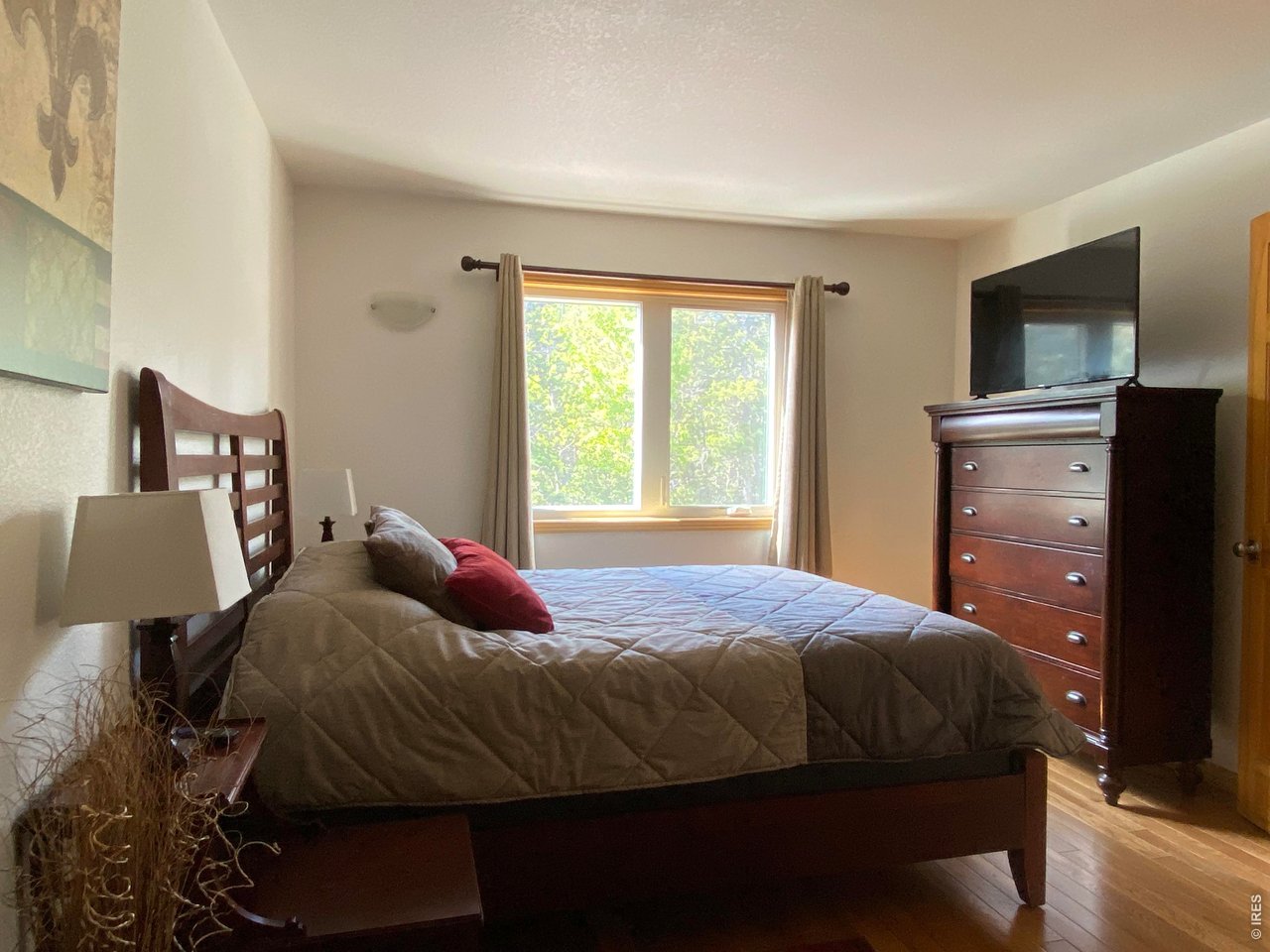 28 Valley View Lane Evergreen, CO 80439 - Photo 20 of 37 a bedroom with a bed and wooden floor