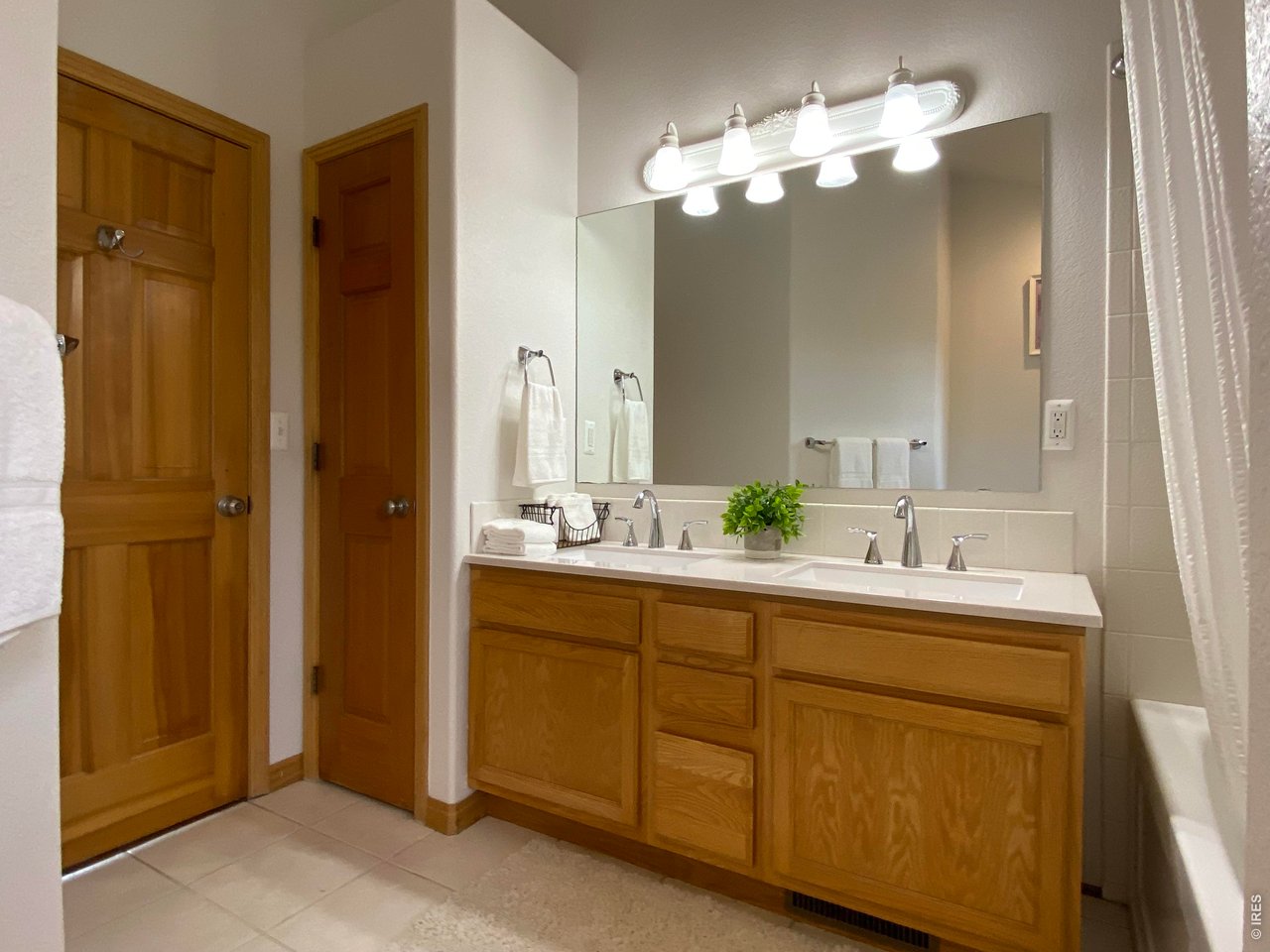 28 Valley View Lane Evergreen, CO 80439 - Photo 23 of 37 a bathroom with a double vanity sink and a mirror