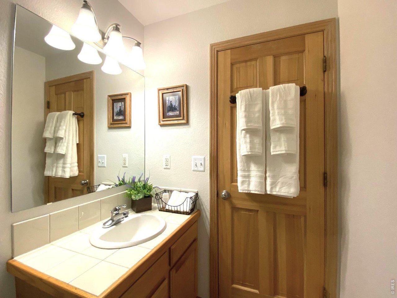 28 Valley View Lane Evergreen, CO 80439 - Photo 26 of 37 a bathroom with a sink vanity and a mirror