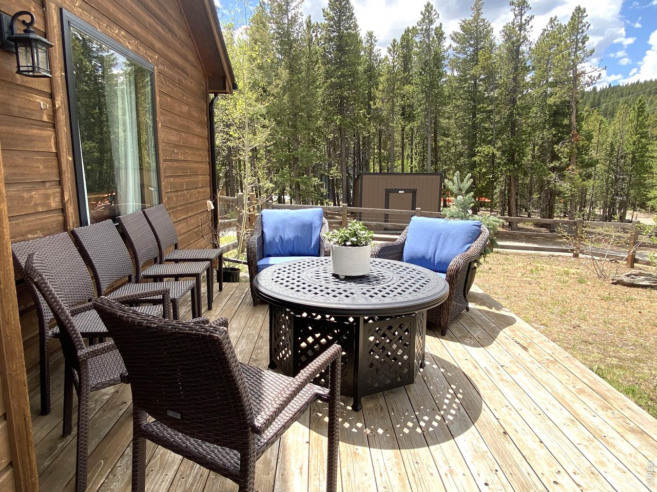 28 Valley View Lane Evergreen, CO 80439 - Photo 29 of 37 a view of a patio with a dining table and chairs