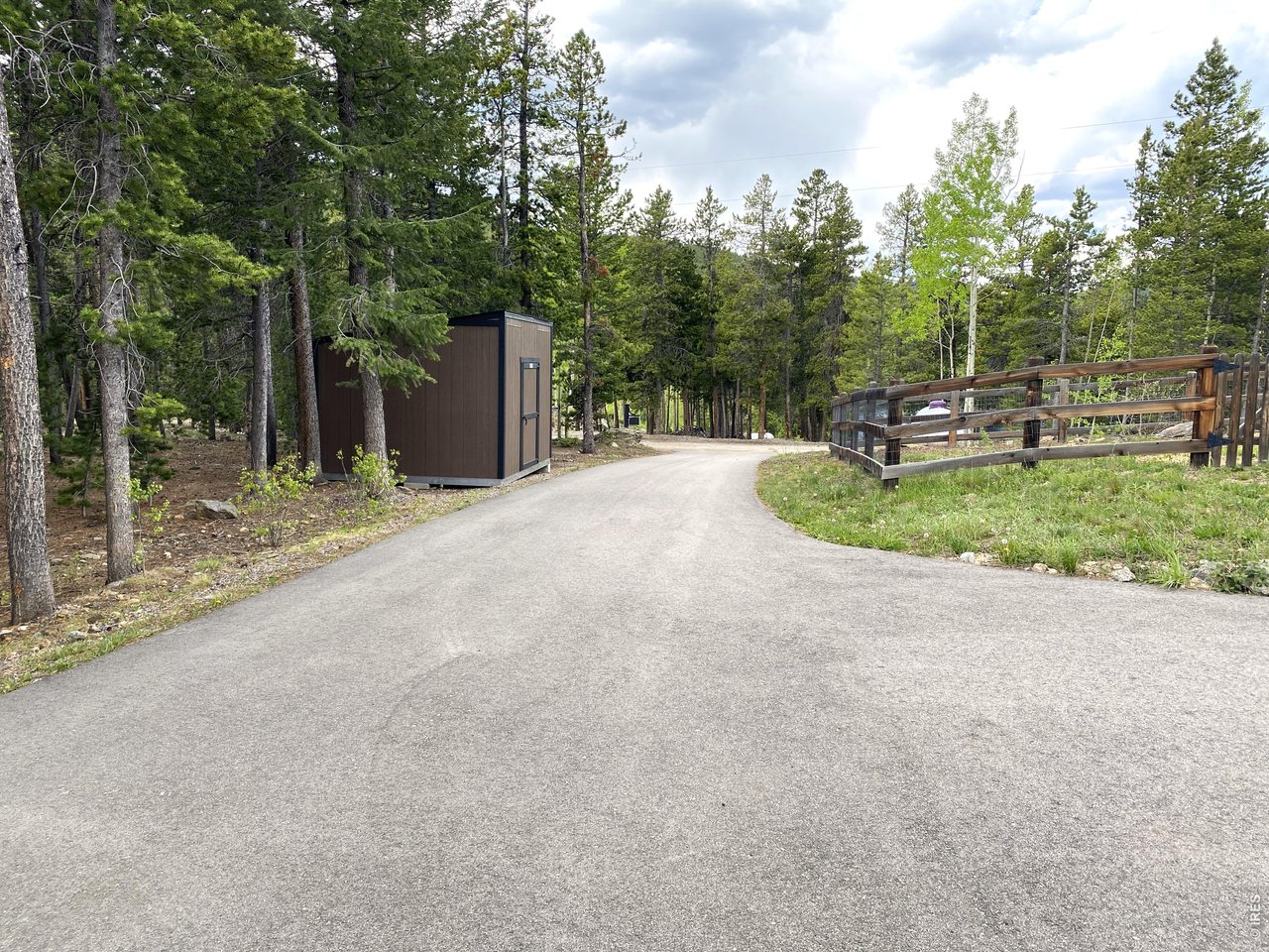 28 Valley View Lane Evergreen, CO 80439 - Photo 36 of 37 a backyard of a house with trees and outdoor seating