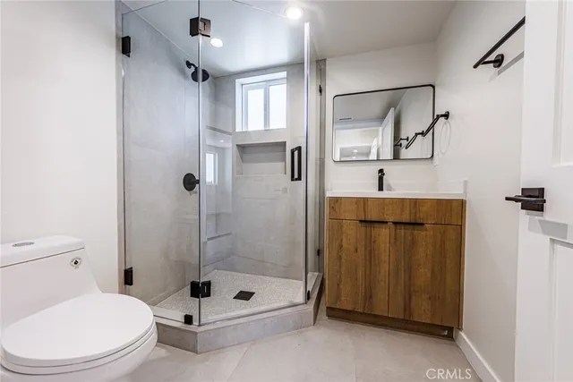 a bathroom with a toilet sink and shower
