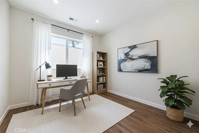 a workspace with furniture and a potted plant