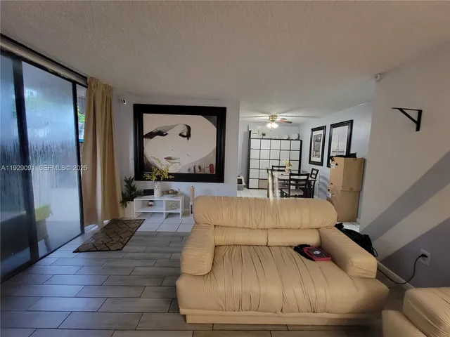 a living room with furniture and a large mirror with painted walls