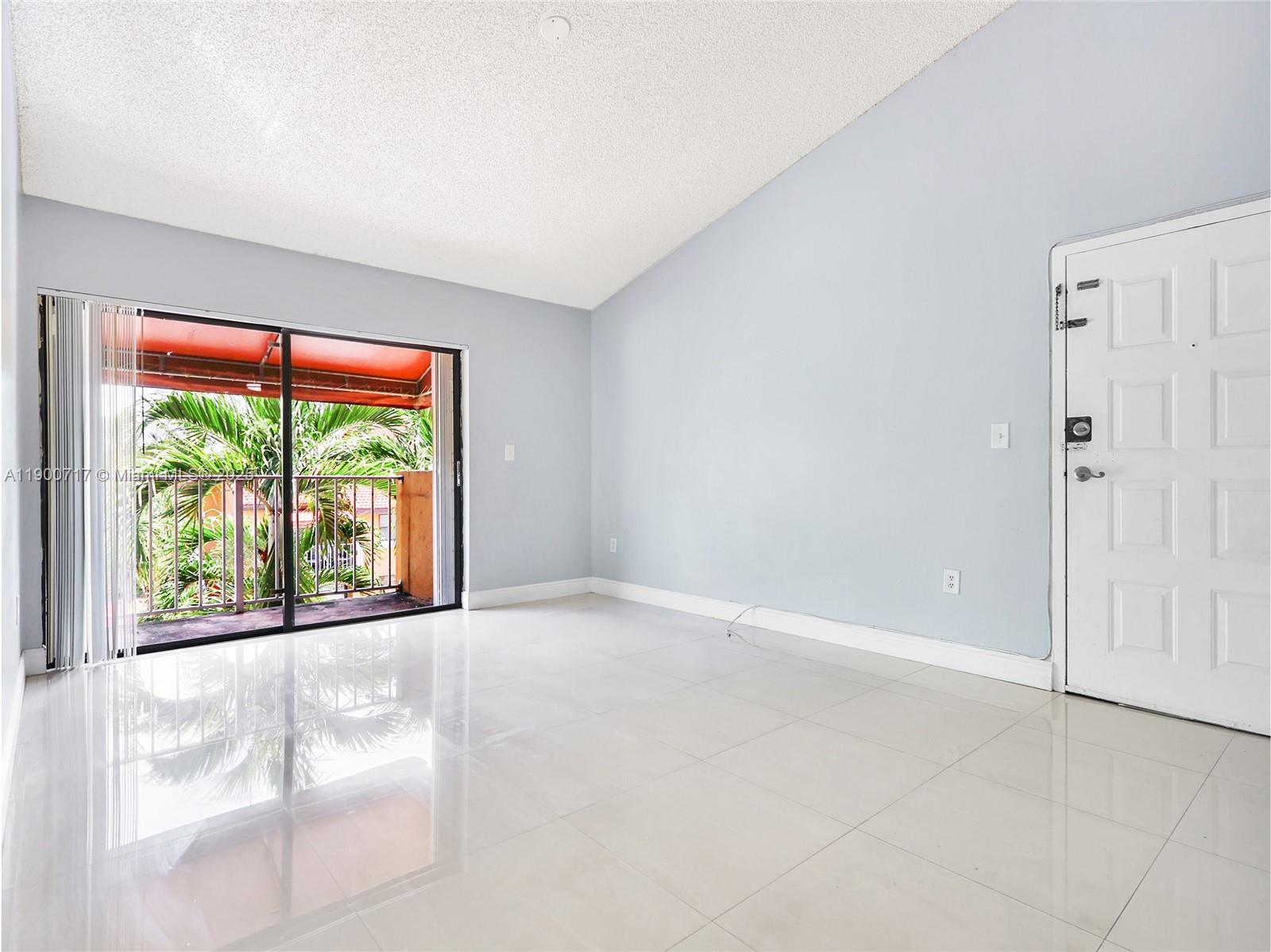 15520 Southwest 80th Street, Unit B301 Miami, FL 33193 - Photo 8 of 25 a view of an empty room with a window