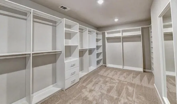 a view of walk in closet with white walls