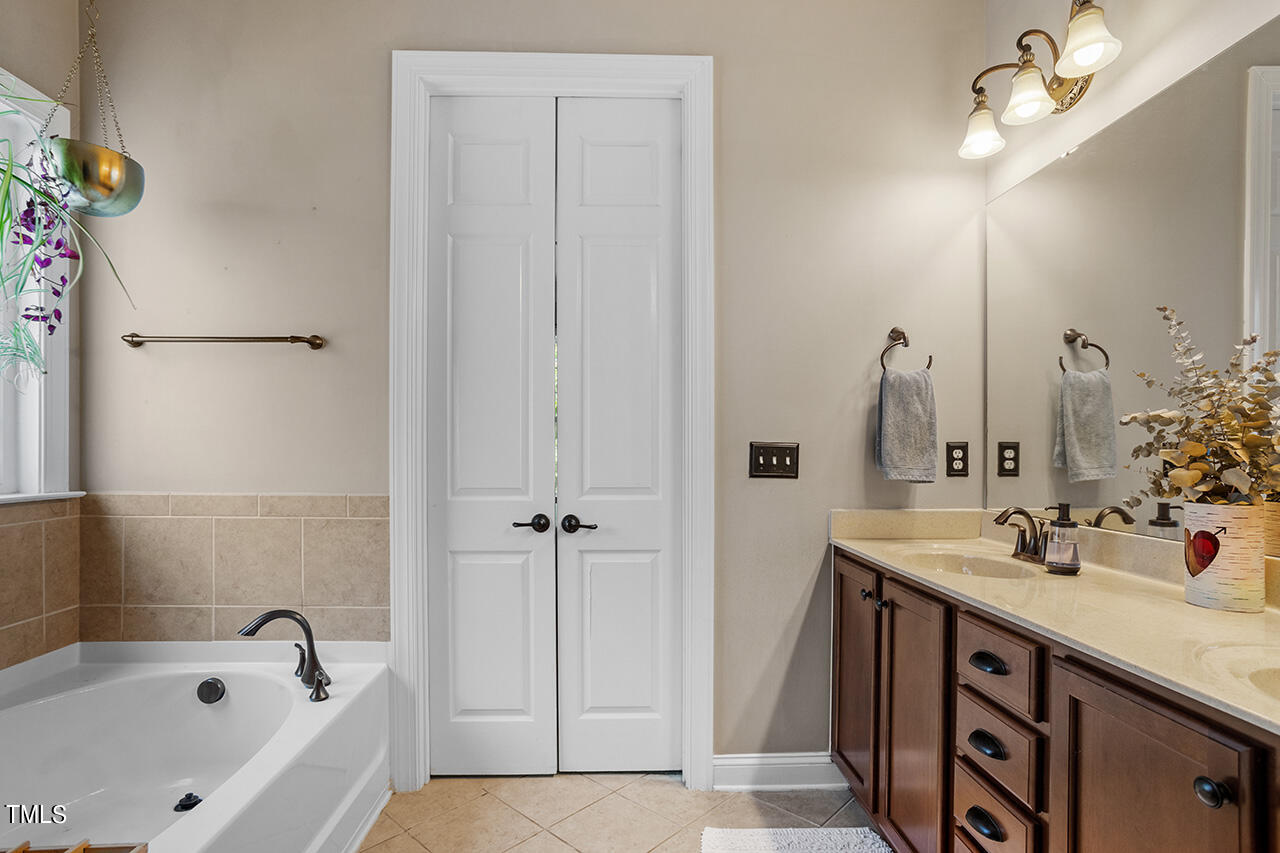 920 Chapanoke Road Raleigh, NC 27603 - Photo 21 of 47 a bathroom with a sink and a bathtub