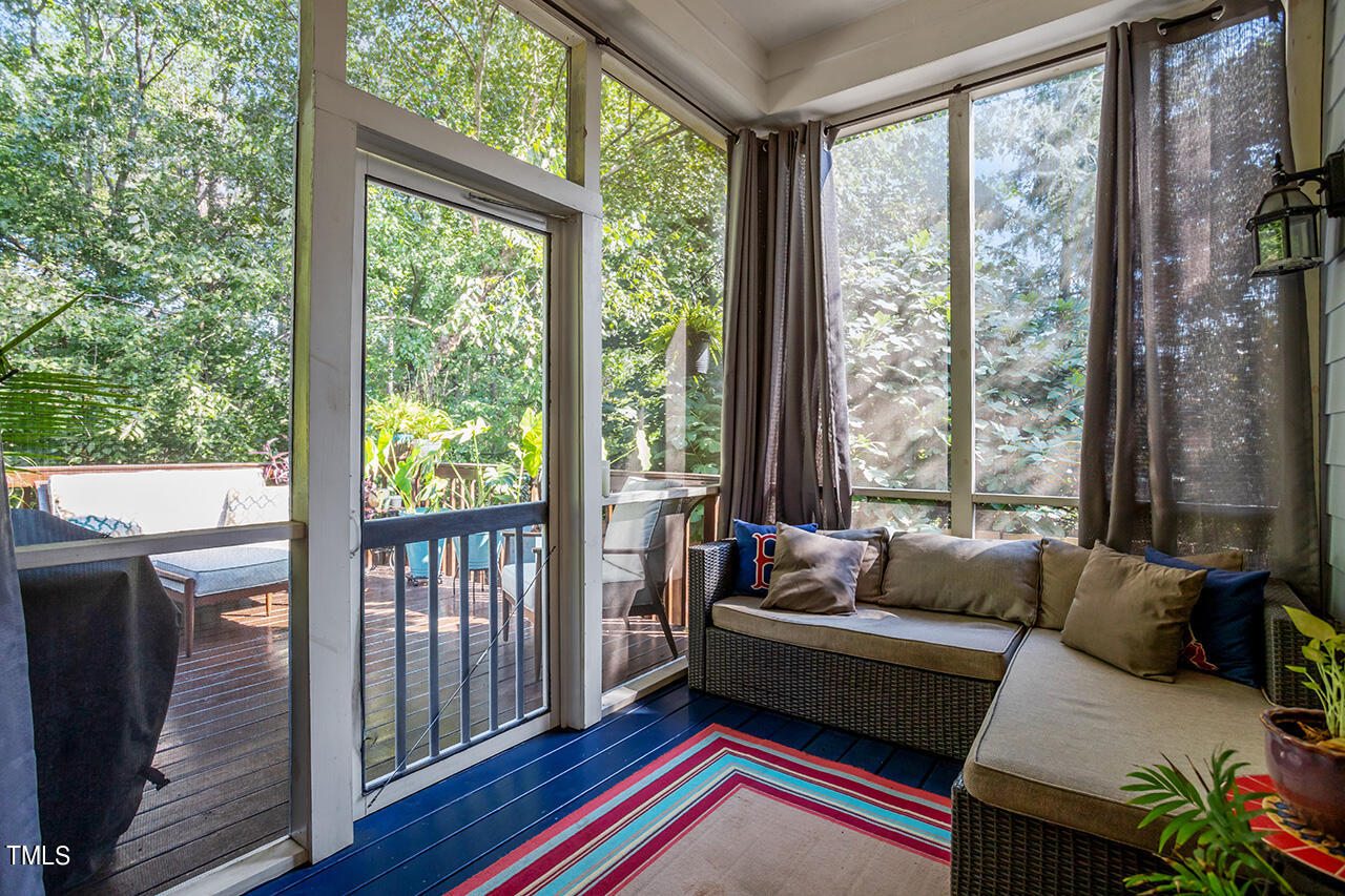 920 Chapanoke Road Raleigh, NC 27603 - Photo 32 of 47 a living room with furniture and a floor to ceiling window