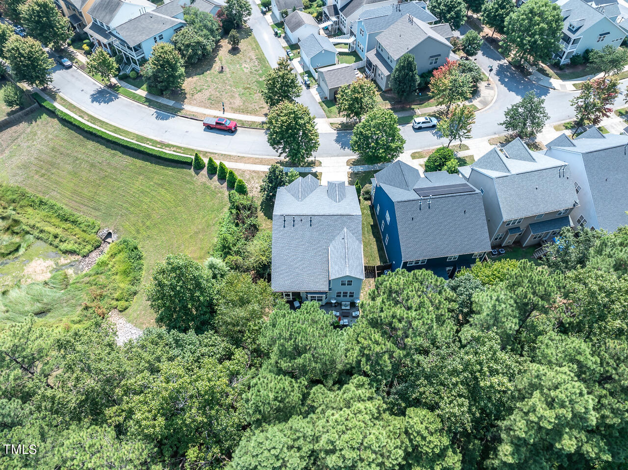 920 Chapanoke Road Raleigh, NC 27603 - Photo 41 of 47 an aerial view of a house with a garden and lake view