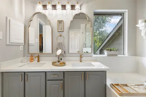 a bathroom with a sink and a large mirror