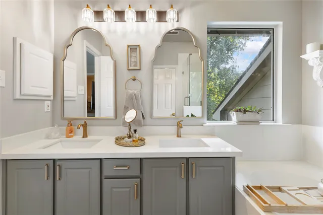 a bathroom with a sink and a large mirror