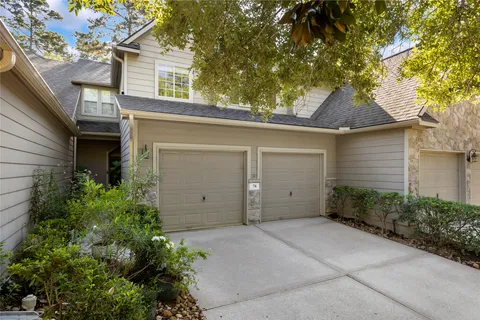 front view of a house with a tree
