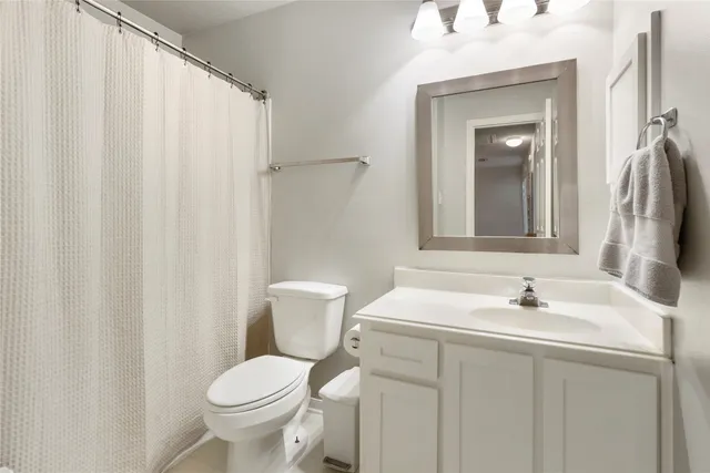 a bathroom with a sink toilet and a mirror