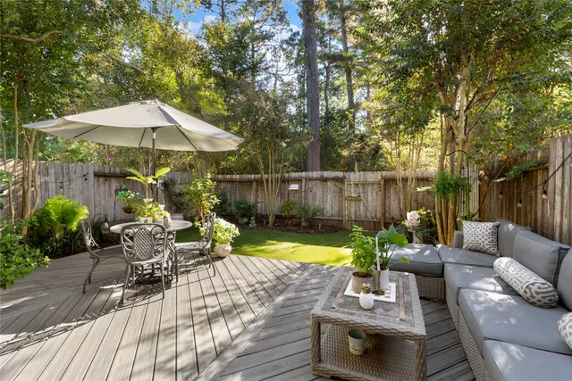 a view of backyard with seating space and trees