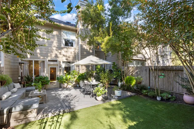 a view of a patio with table and chairs under an umbrella