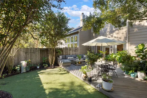 a view of a house with swimming pool and sitting area