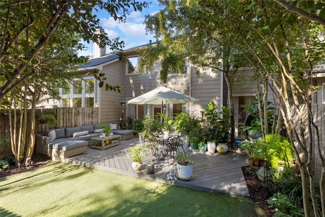 a view of a patio with chairs and potted plants