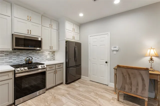 a kitchen with a refrigerator stove and microwave
