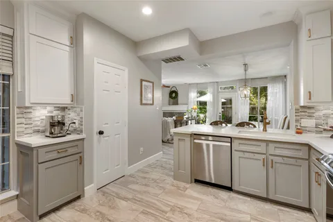 a kitchen with stainless steel appliances granite countertop a sink and cabinets