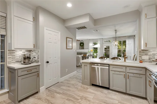 a kitchen with stainless steel appliances granite countertop a sink and cabinets