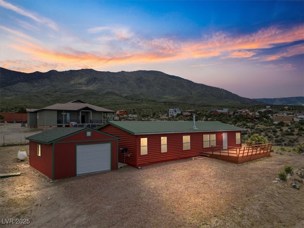 70 West Bonanza Road Las Vegas, NV 89124 - Photo 2 of 71 View of front of house featuring a deck with mountain view, faux log siding, and an outbuilding