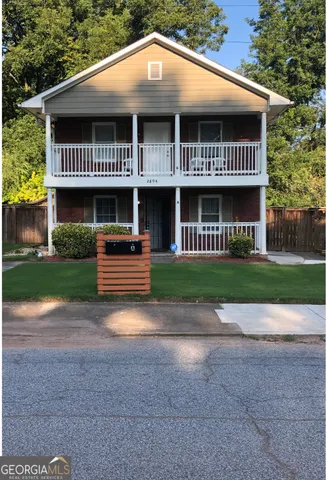 a view of a house with a yard and plants