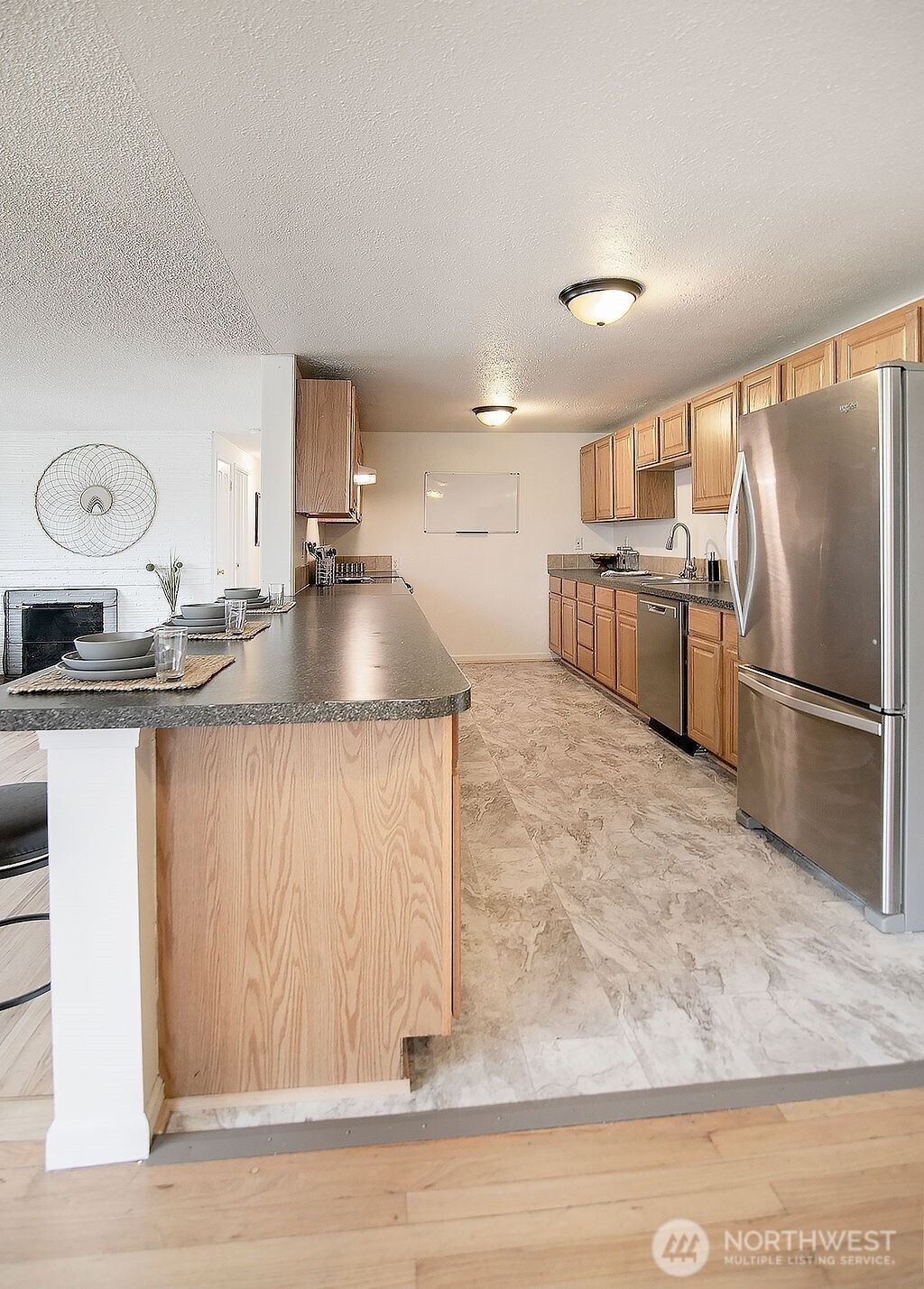 1925 28th Avenue Longview, WA 98632 - Photo 11 of 37 a large kitchen with stainless steel appliances granite countertop a sink a stove and a refrigerator