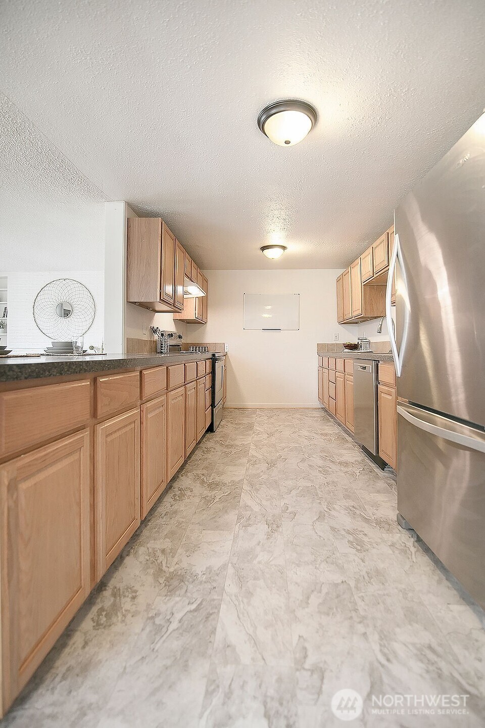 1925 28th Avenue Longview, WA 98632 - Photo 12 of 37 a large white kitchen with sink refrigerator and cabinets