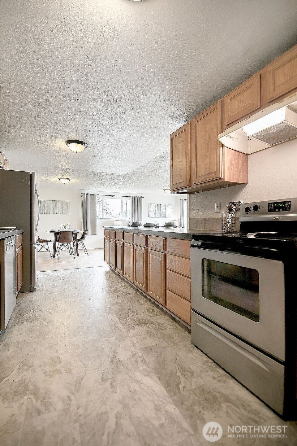 1925 28th Avenue Longview, WA 98632 - Photo 14 of 37 a kitchen with a stove and white cabinets