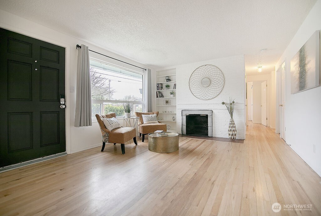 1925 28th Avenue Longview, WA 98632 - Photo 3 of 37 a view of a livingroom with furniture a fireplace and wooden floor