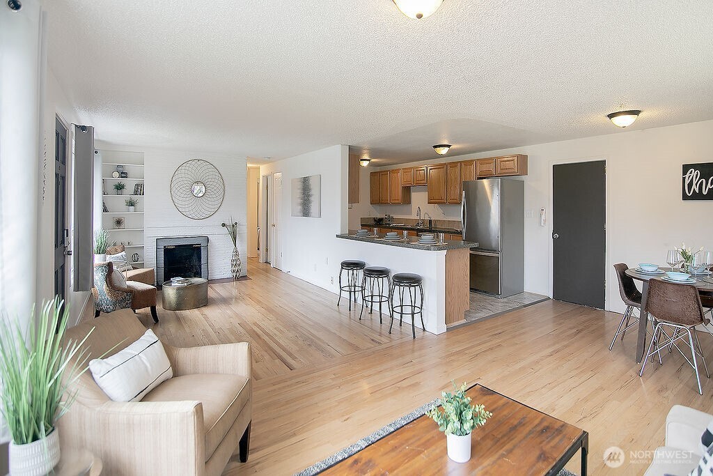 1925 28th Avenue Longview, WA 98632 - Photo 5 of 37 a living room with furniture a fireplace and a flat screen tv