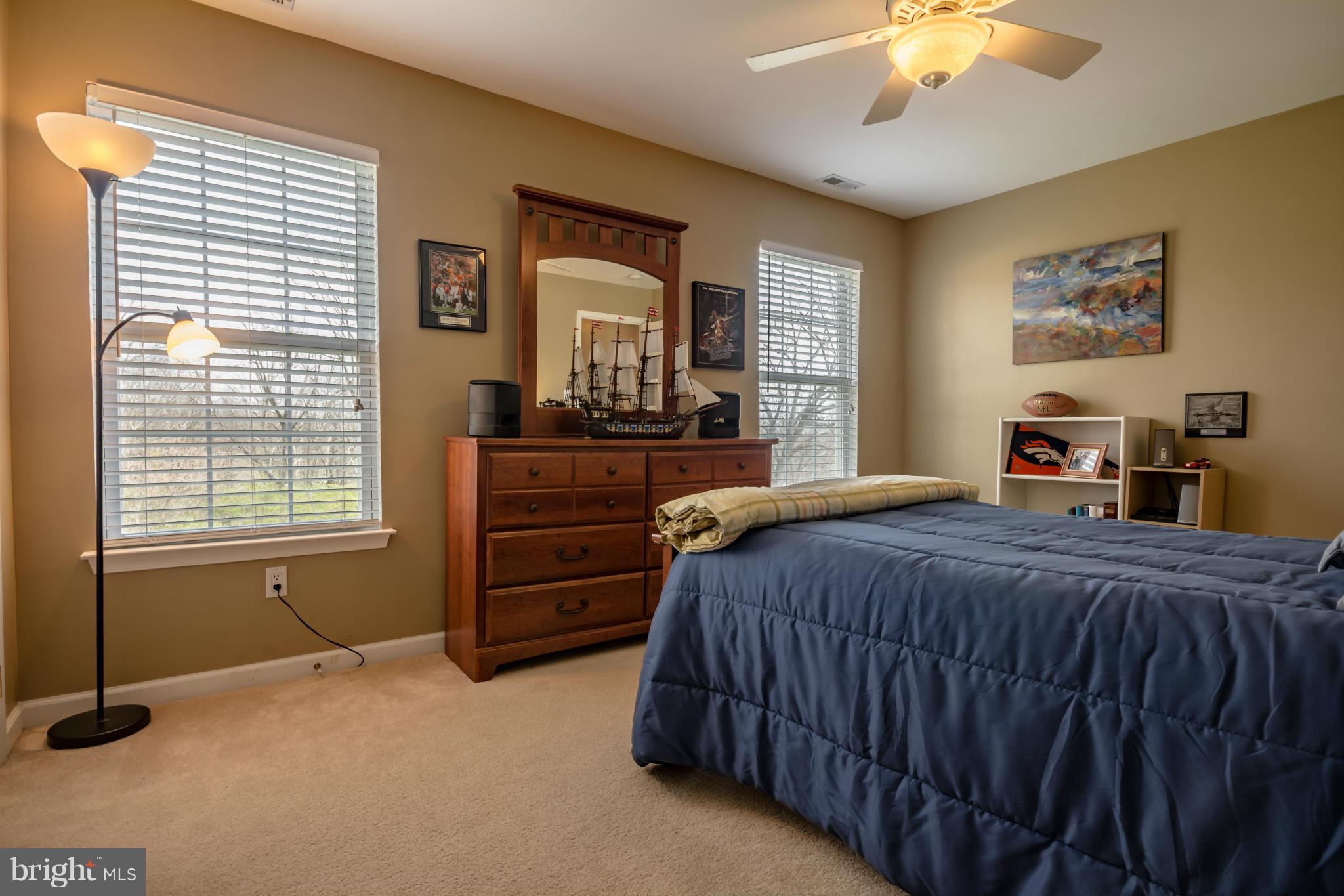 171 Wright Road Winchester, VA 22603 - Photo 24 of 30 a bedroom with a bed and a chandelier